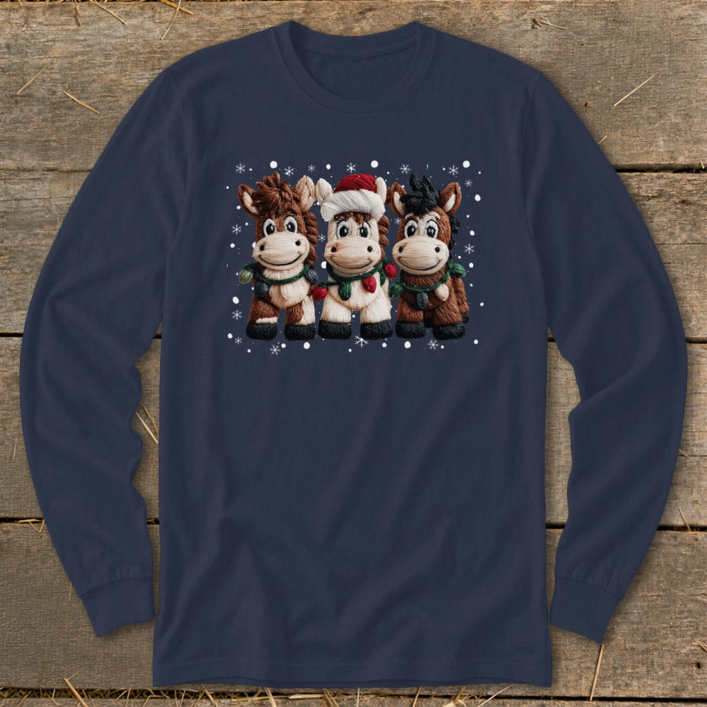 Three cartoon horses with Christmas lights and snowflakes on a navy long-sleeve shirt.