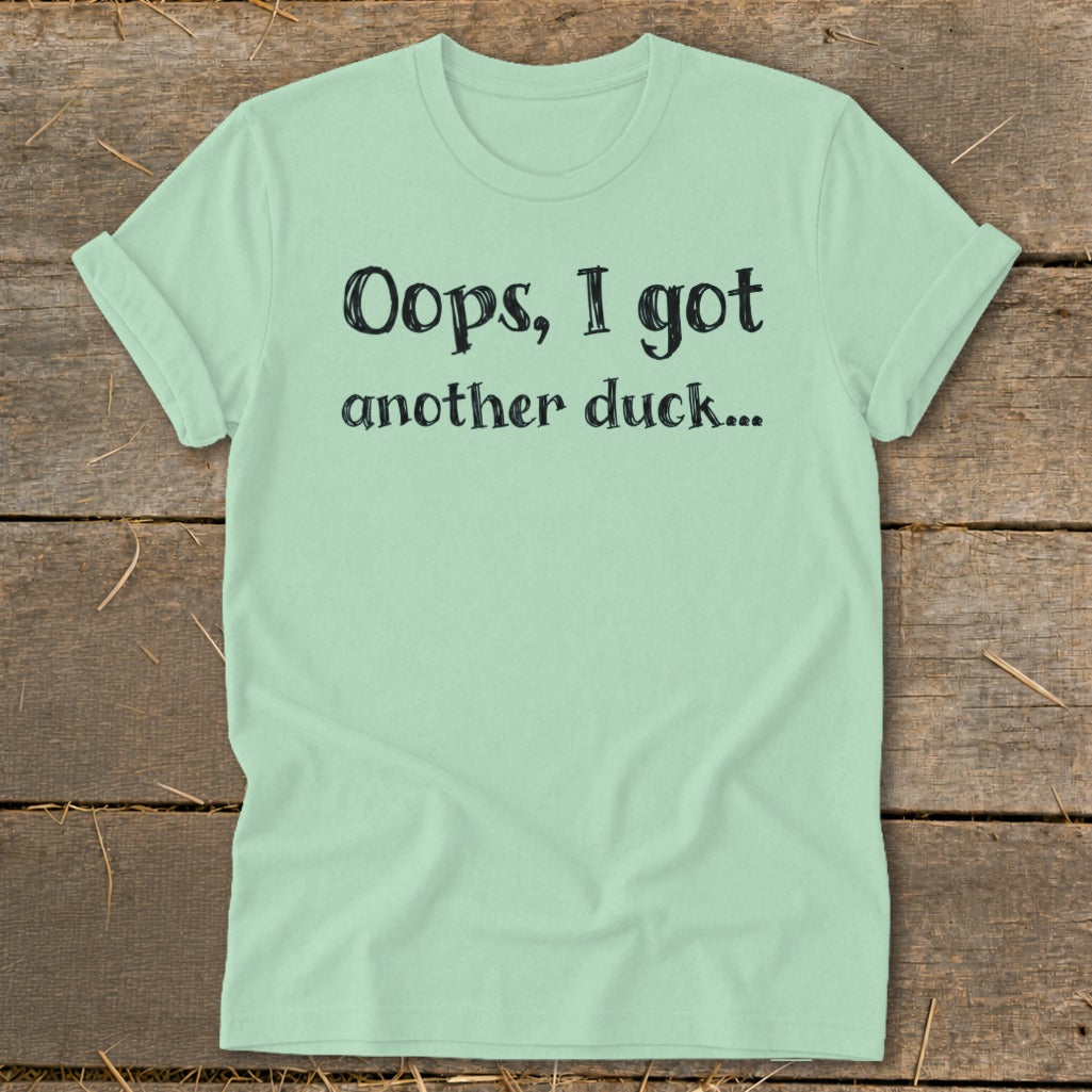 Light green t-shirt with black text that reads "Oops, I got another duck..."