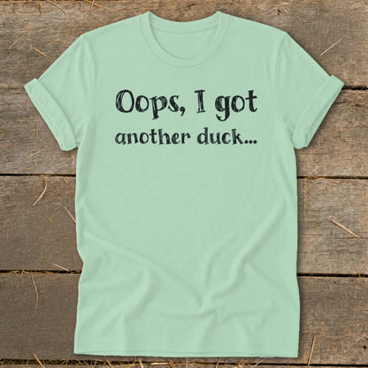 Light green t-shirt with black text that reads "Oops, I got another duck..."