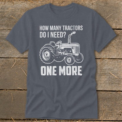 Gray t-shirt with white text "HOW MANY TRACTORS DO I NEED? ONE MORE" and tractor graphic.