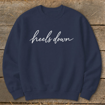 Navy blue sweatshirt with "heels down" in white cursive text.
