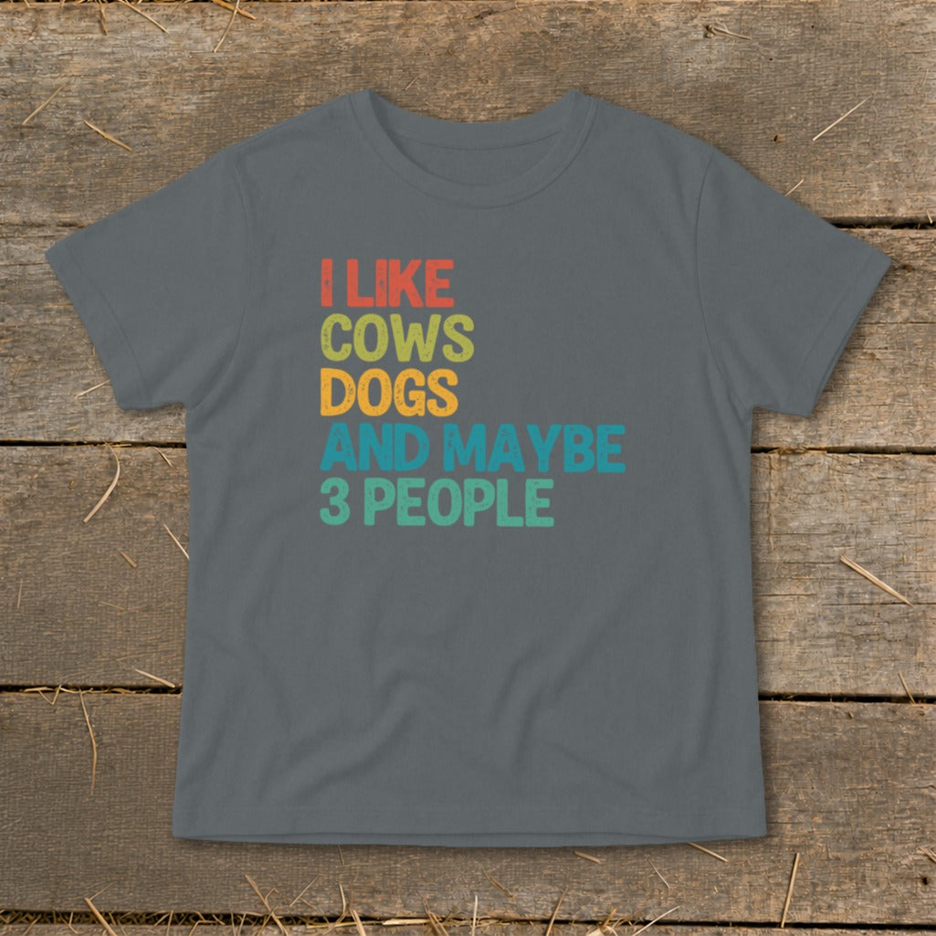 A grey short-sleeved t-shirt with multicolored text stating, "I like cows, dogs, and maybe 3 people."