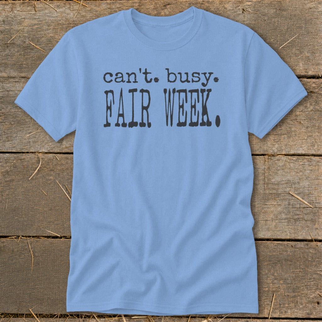 Light blue t-shirt with black text that reads "can't. busy. FAIR WEEK."