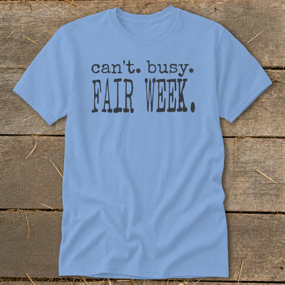 Light blue t-shirt with black text that reads "can't. busy. FAIR WEEK."