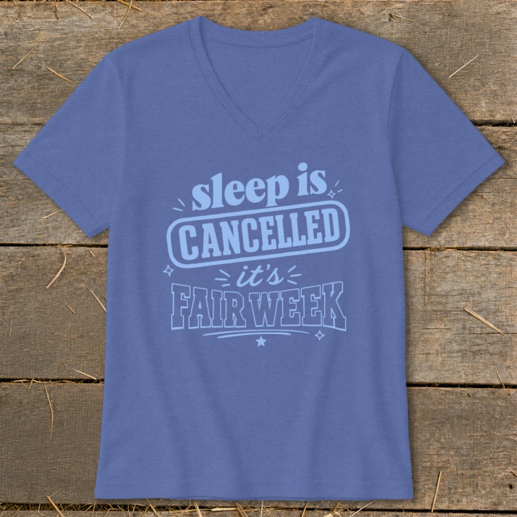 Blue v-neck t-shirt with "sleep is CANCELLED it's FAIR WEEK" graphic.