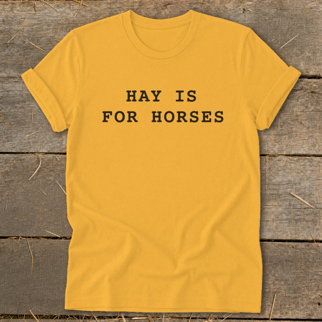 Yellow t-shirt with black text reading "HAY IS FOR HORSES".