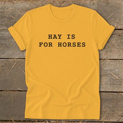 Yellow t-shirt with black text reading "HAY IS FOR HORSES".