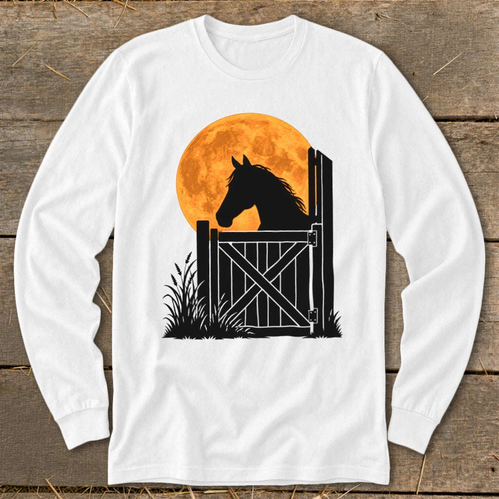 A white long-sleeved t-shirt featuring a black silhouette of a horse looking out a stable door against a large orange moon.
