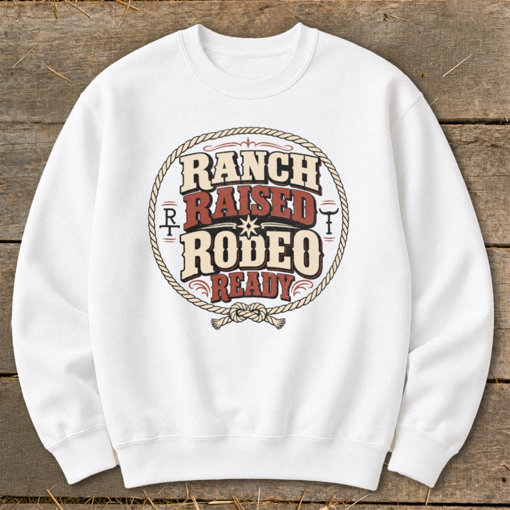 White sweatshirt with "Ranch Raised Rodeo Ready" graphic in a rope circle.