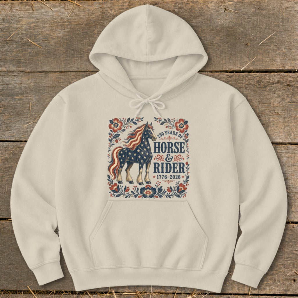 Cream hoodie with a graphic of a horse and rider, 250 years of horse and rider 1776-2026.