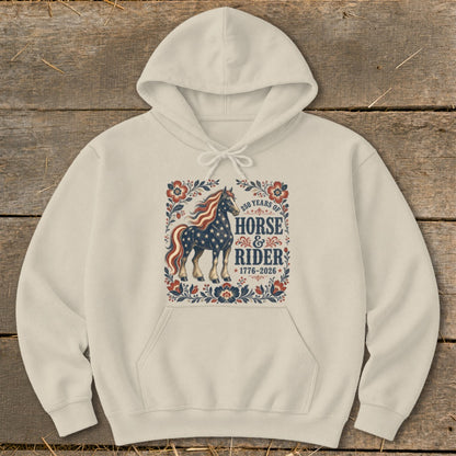 Cream hoodie with a graphic of a horse and rider, 250 years of horse and rider 1776-2026.