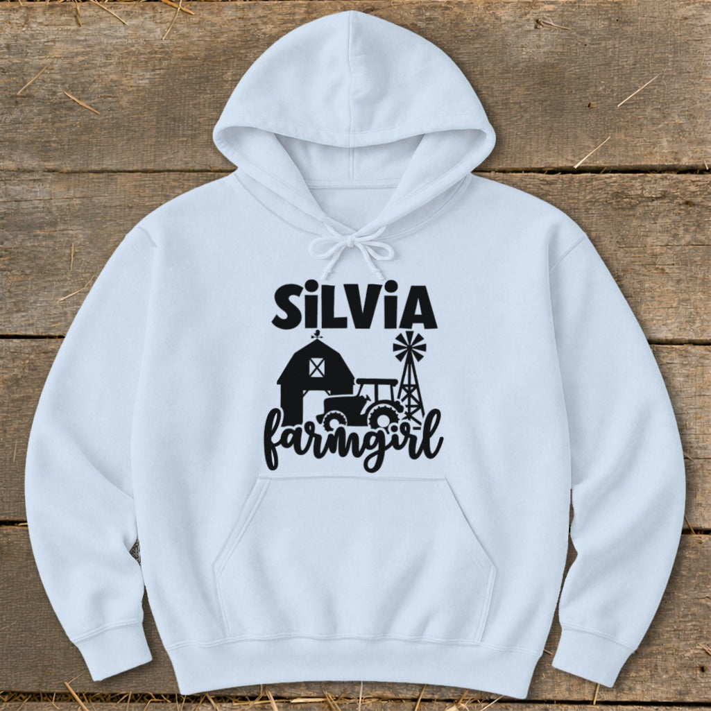 White hoodie with black "Silvia farmgirl" text and farm graphic.