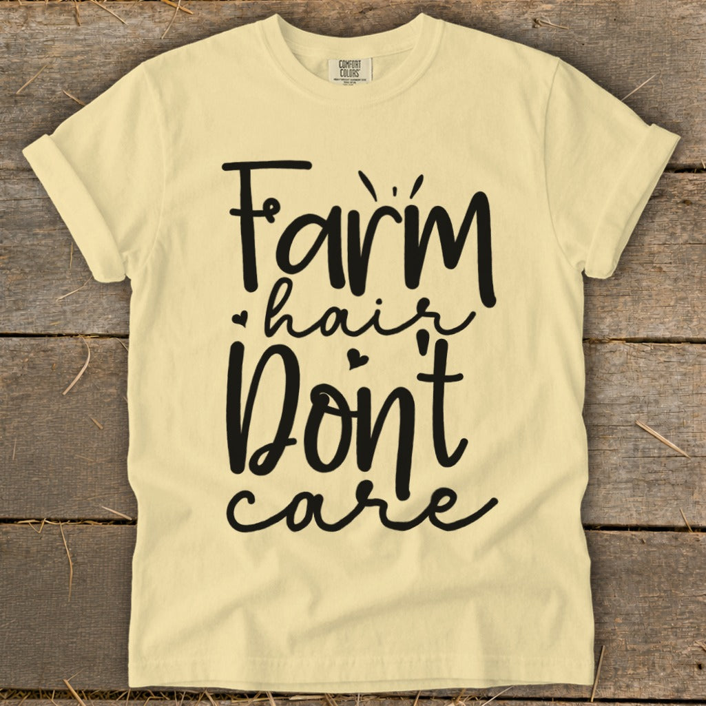 Pale yellow t-shirt with "Farm hair Don't care" graphic print.