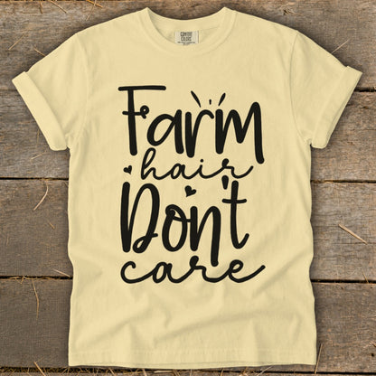 Pale yellow t-shirt with "Farm hair Don't care" graphic print.