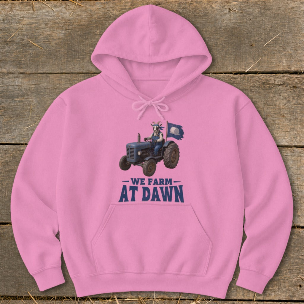 Pink hoodie with graphic of goat driving tractor and text "We Farm At Dawn".