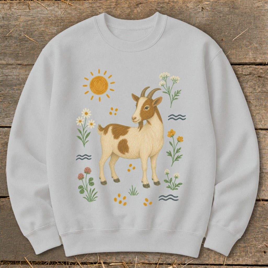 Light gray crewneck sweatshirt with a brown and white goat, sun, and floral illustrations.