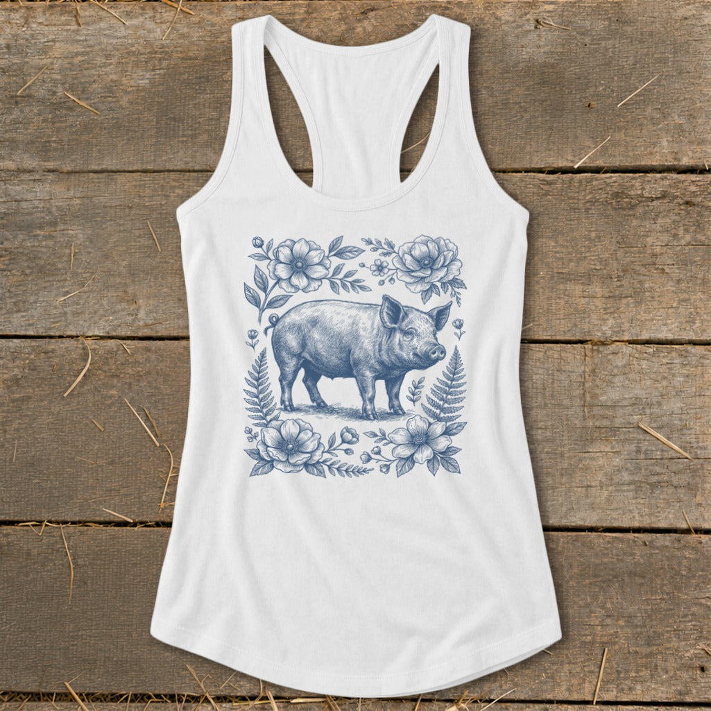 White tank top with blue pig and floral illustration on the front.