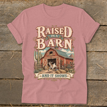 T-shirt graphic: "Raised in a Barn and It Shows" with a goat and barn scene.