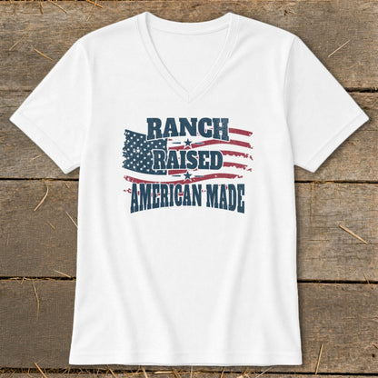 White v-neck t-shirt with distressed American flag graphic and text.