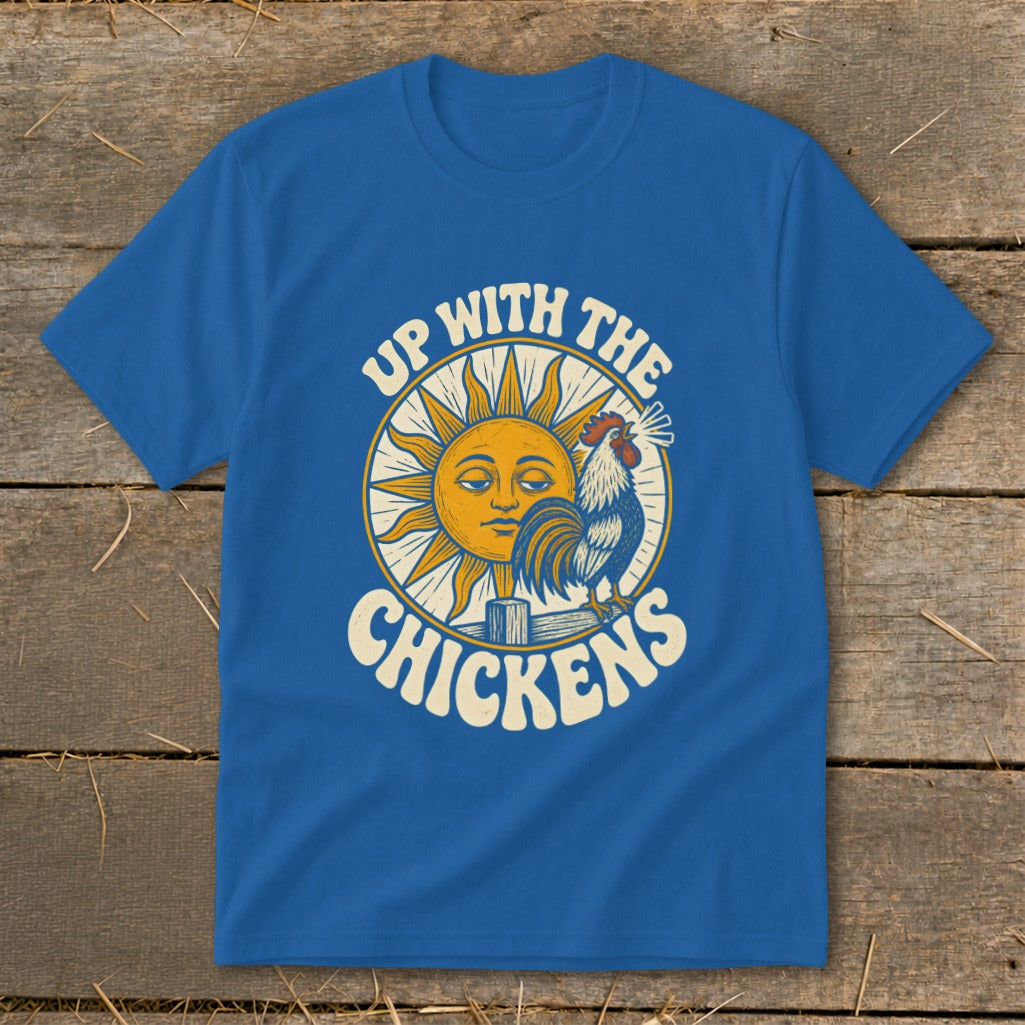 A royal blue t-shirt printed with a yellow sun, crowing rooster, and text reading Up With The Chickens.