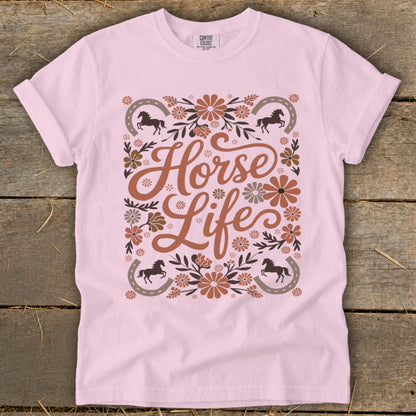 Light pink t-shirt with "Horse Life" text, horses, horseshoes, and floral accents.