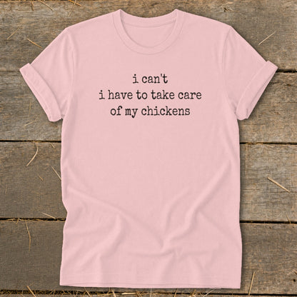 Pink t-shirt with black text: "i can't i have to take care of my chickens".