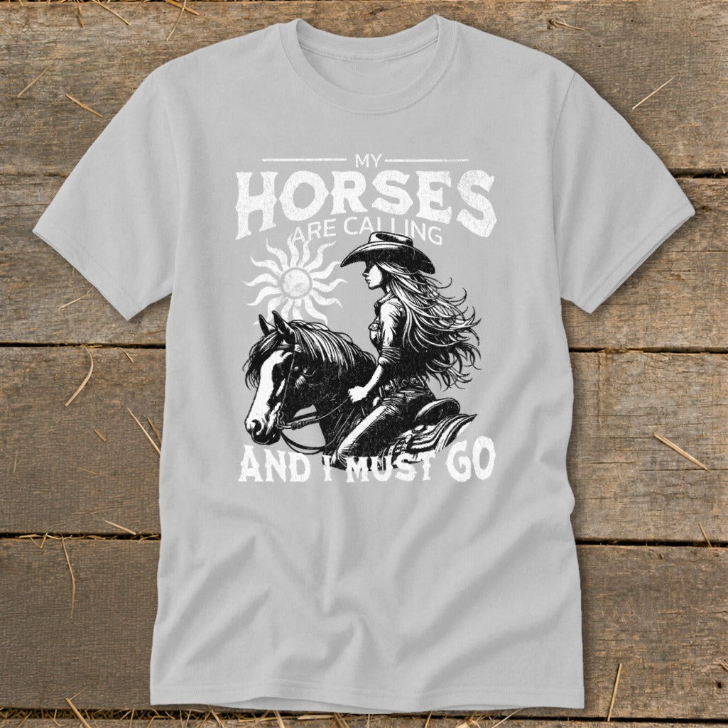 T-shirt graphic with woman on horse and text "My horses are calling and I must go".