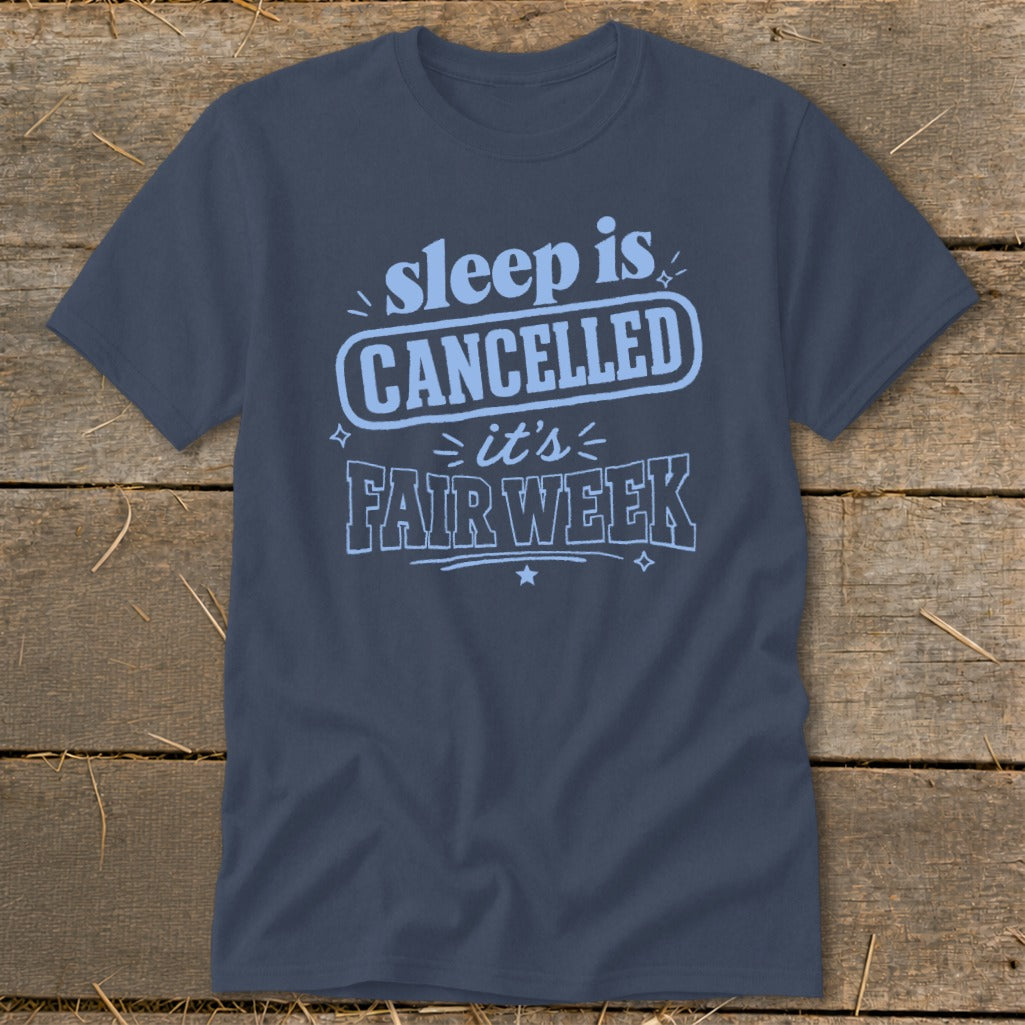 Blue t-shirt with "sleep is CANCELLED it's FAIR WEEK" text.