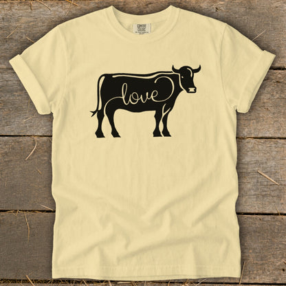 Light yellow t-shirt with a black cow outline filled with the word "love".