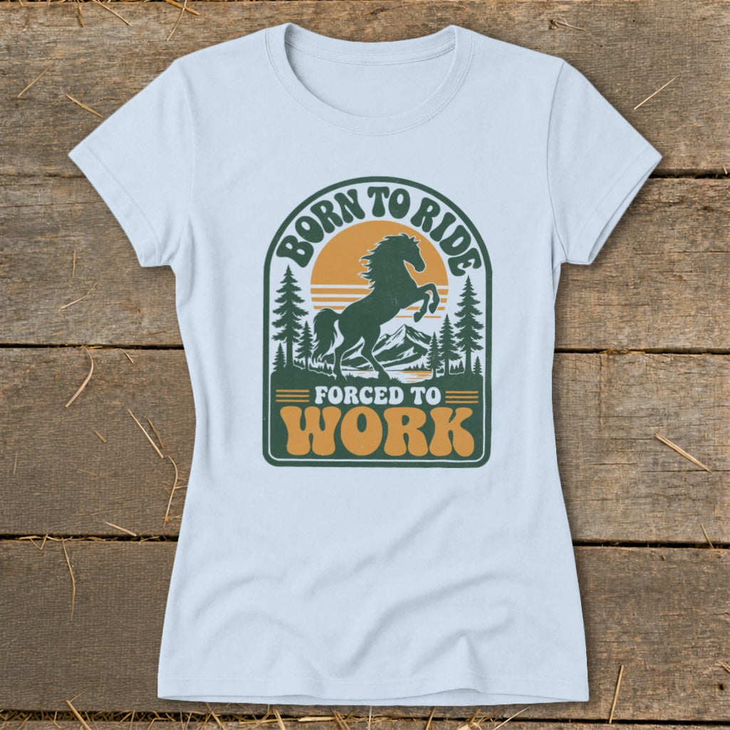 T-shirt with graphic of horse, trees, mountains, and text "BORN TO RIDE FORCED TO WORK".