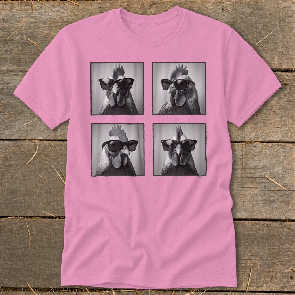 Pink t-shirt with four black and white portraits of roosters wearing sunglasses.