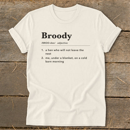Cream t-shirt with the definition of "Broody" printed on it.