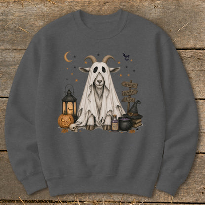 Goat dressed as a ghost with Halloween elements and spooky sign.