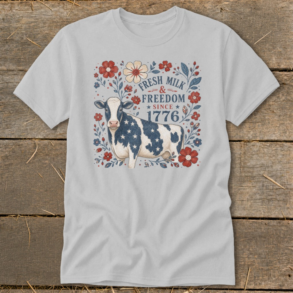 Light gray t-shirt with a cow design featuring American flag stars and "Fresh Milk & Freedom Since 1776."
