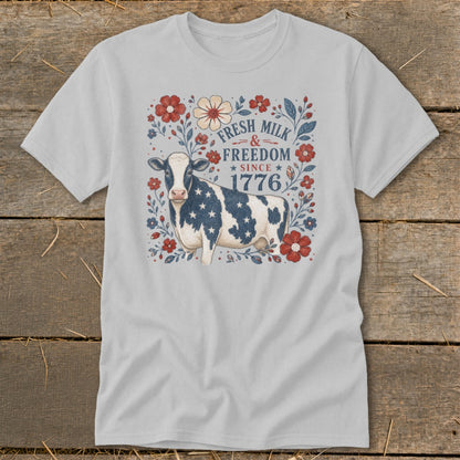 Light gray t-shirt with a cow design featuring American flag stars and "Fresh Milk & Freedom Since 1776."