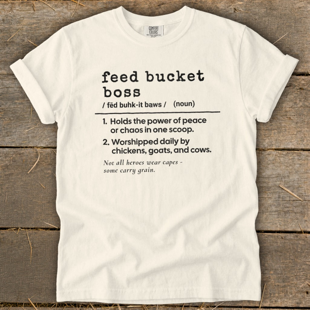 White t-shirt with black text defining "feed bucket boss" and a related quote.