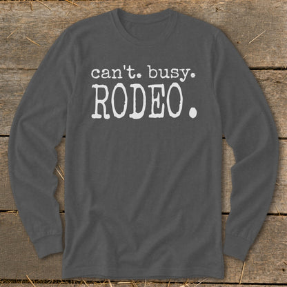 Dark grey long sleeve shirt with white text that reads "can't. busy. RODEO."