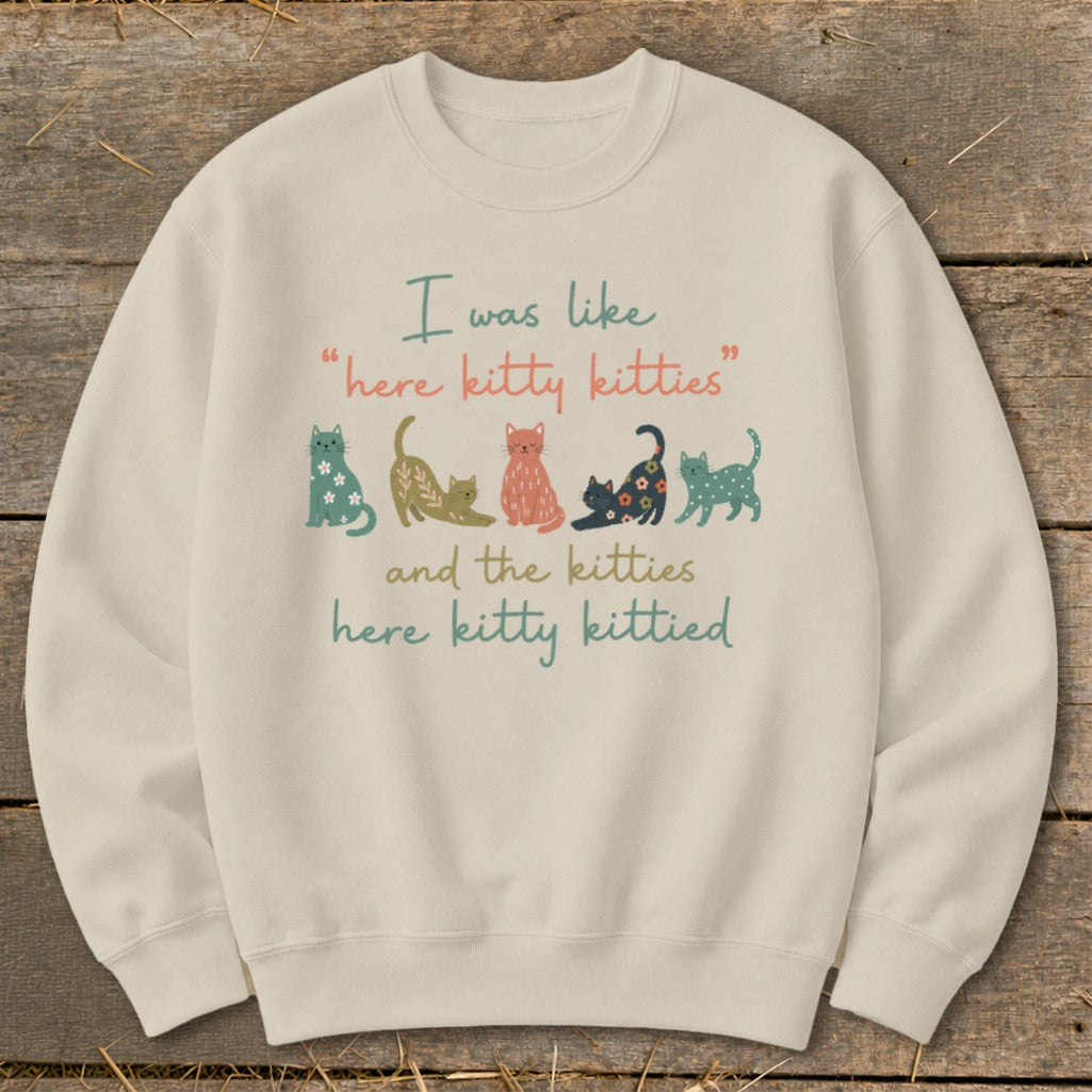 Cream sweatshirt with text and cartoon cats: "I was like 'here kitty kitties' and the kitties here kitty kittied."