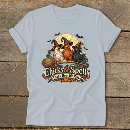 Three chickens in witch hats sit on a broomstick with "Chicks & Spells" text.