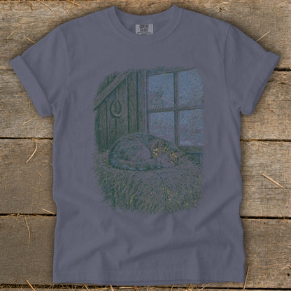 T-shirt with graphic of a sleeping cat by a frosted window in a barn.