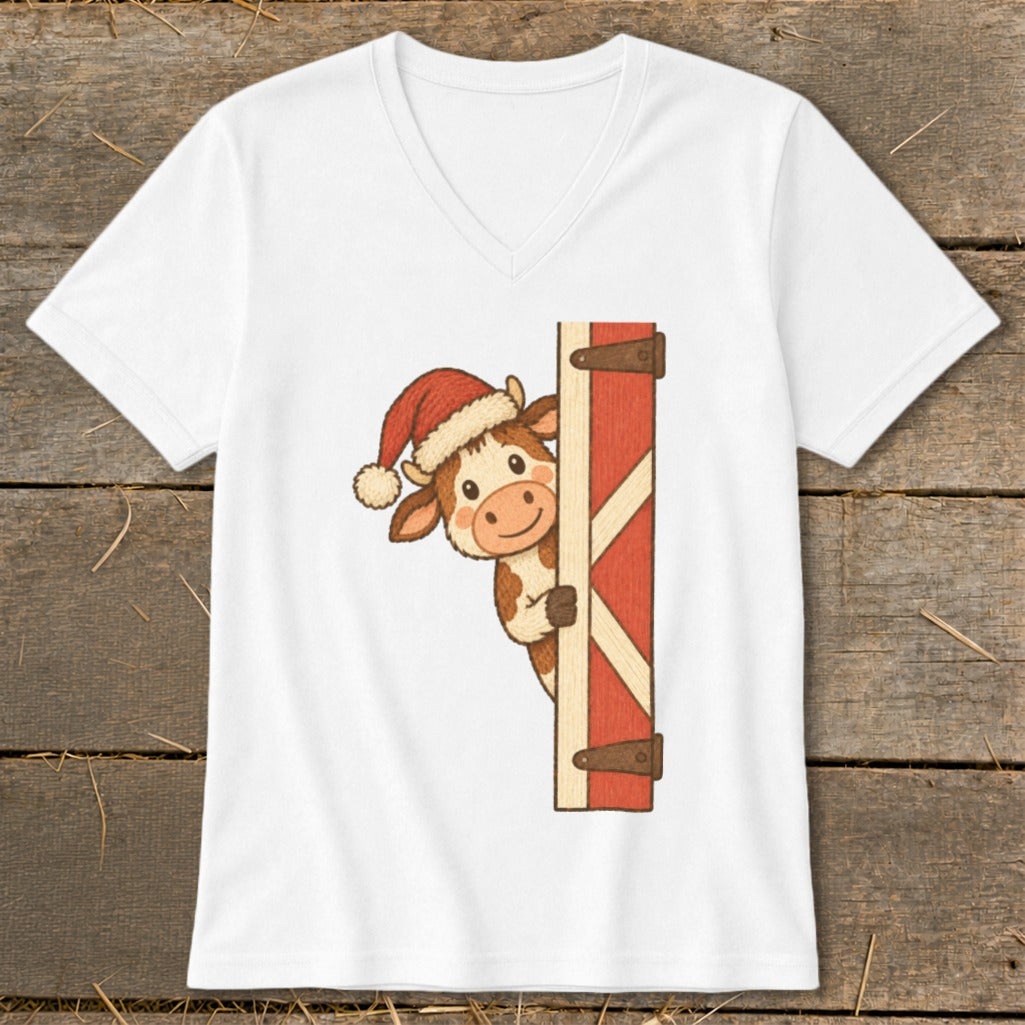 Cute cartoon cow wearing a Santa hat peeking around a red barn door.
