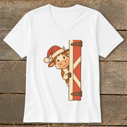 Cute cartoon cow wearing a Santa hat peeking around a red barn door.