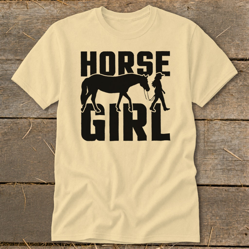 Light yellow t-shirt with black text and silhouette reading "HORSE GIRL" with horse and rider.