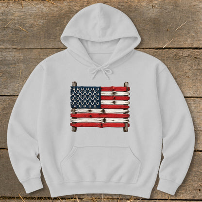 A white hooded sweatshirt features a graphic of an American flag made from painted wooden planks and horseshoes.