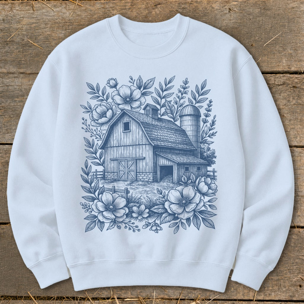 Light blue sweatshirt with a barn and floral sketch print.
