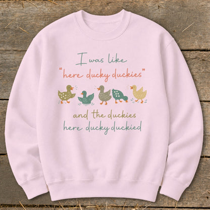 Pink sweatshirt with ducks and text "I was like 'here ducky duckies' and the duckies here ducky duckied"