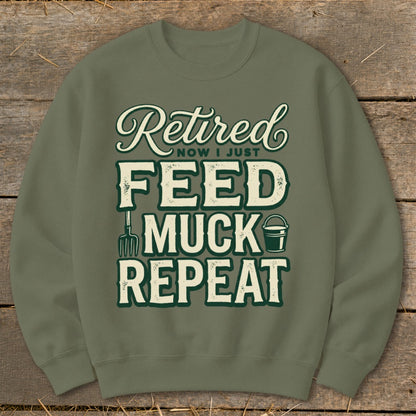 Olive green sweatshirt with "Retired Now I Just Feed Muck Repeat" text and gardening graphics.