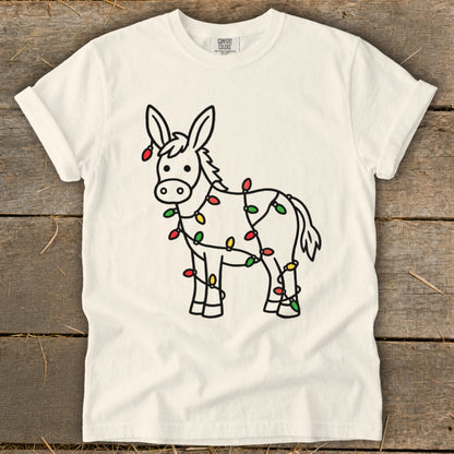 Donkey adorned with colorful Christmas lights, Comfort Colors shirt.