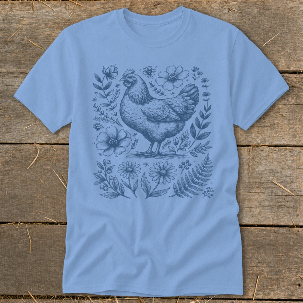 Light blue t-shirt with a vintage chicken and floral illustration.