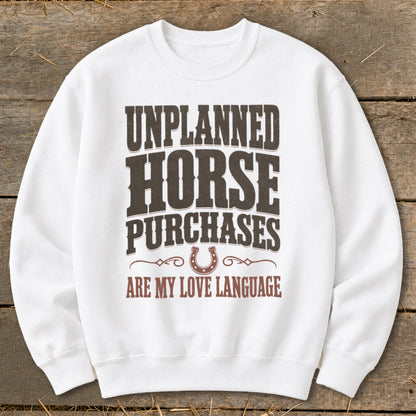 White sweatshirt with "Unplanned Horse Purchases Are My Love Language" text.